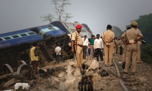 Indian policemen stand by a train that derailed near Jagiroad Railway Station, India.