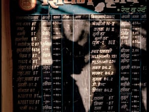 A black board with a list of all the GM Bt seeds available for sale in a seed shop in Yavatmal, India