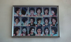 Photos showing example hair styles hang inside a hair salon in Pyongyang in 2013.