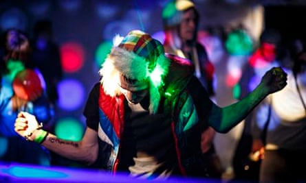 A man dances at an illegal rave in an abandoned warehouse in east London.
