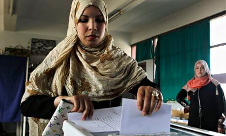 A woman casts her ballot during presidential election in Algiers