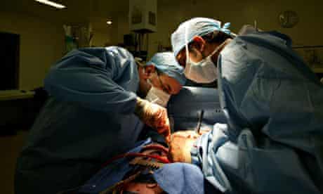 Cardiac surgeons replace a heart valve. 