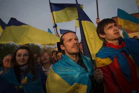 Ukrainians with their national flags gather in support of a united Ukraine in Donetsk, Ukraine, Thursday April 17, 2014.