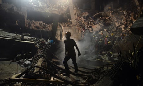 A Bangladeshi worker leaves the site where a garment factory building collapsed near Dhaka, Bangladesh.