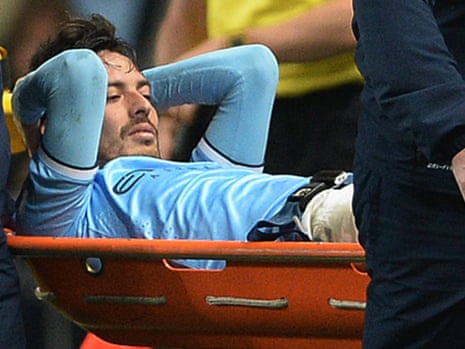 Manchester City's David Silva leaves the field on a stretcher.