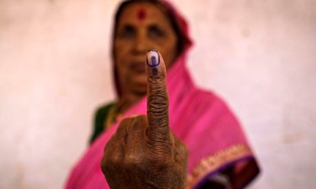 A woman shows her ink-marked finger 