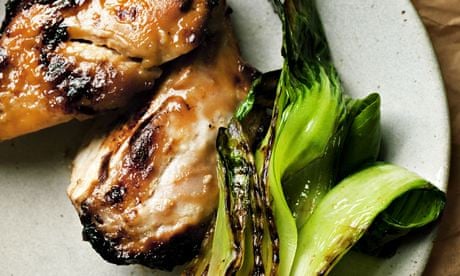 Grilled miso chicken on a round plate with pak choi