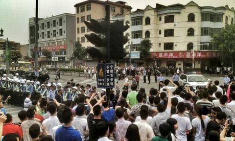 Striking workers protest near the Yue Yuen shoe factory complex in Dongguan