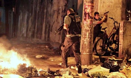 Military police on patrol near a burning barricade in Rio