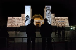 Images from the collection  and battle place names are projected onto the wall of the memorial as the crowds begin to build from as eraly as 2.30am