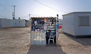 Syrian refugee Abu Mohammed sits in a kiosk selling women's accessories at Zaatari refugee camp, near the Syrian border in Jordan.