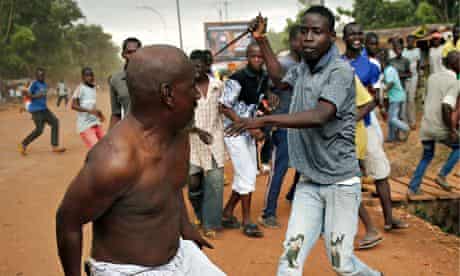 A Christian man chases a suspected Seleka rebel in Bangui, Central African Republic