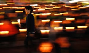 A boy takes part in a candlelight vigil in Ansan to commemorate the victims of the sunken passenger ship Sewol.