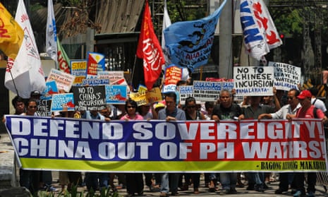 Protesters display a banner and placards while marching towards the Chinese consulate in Manila. philippines
