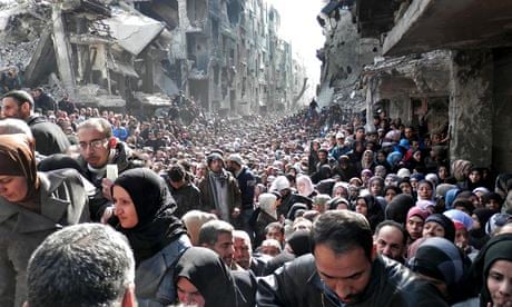 Residents of the besieged Palestinian camp of Yarmouk, in Damascus, Syria