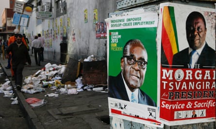 Election campaign posters for Robert Mugabe and his rival Morgan Tsvangirai in 2013.