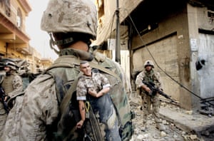 This photograph of a US marine carrying a lucky mascot as his unit pushes further into the western part of Fallujah won a Pulitzer prize in breaking news photography as part of a series of pictures of bloody combat in Iraq in 2004