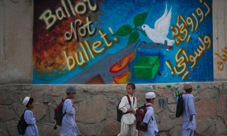 In this March 12, 2014 photo, school children pass by graffiti on the outskirts of Kandahar, southern Afghanistan. Photograph: Anja Niedringhaus/AP