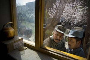 20 Photos: A soldier and a policeman queue for their registration cards in Kabul