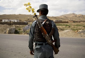 20 Photos: An Afghan national police officer mans a checkpoint near Maidan Shahr