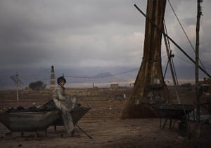 20 Photos: Afghan day labourer Mesbah, 12, takes a rest at a factory near Kabul