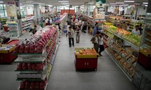 People shop at a supermarket in Pyongyang on July 28, 2013