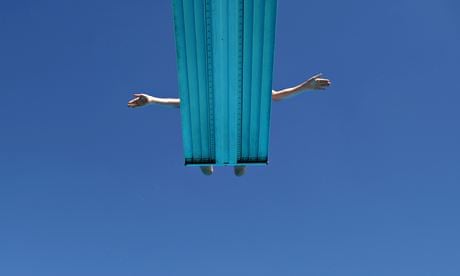 A boy prepares to jump into a swimming pool