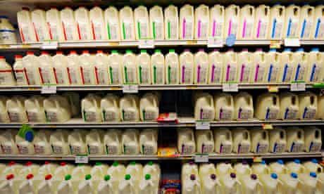 Coloured milk bottle tops on the supermarket shelf.