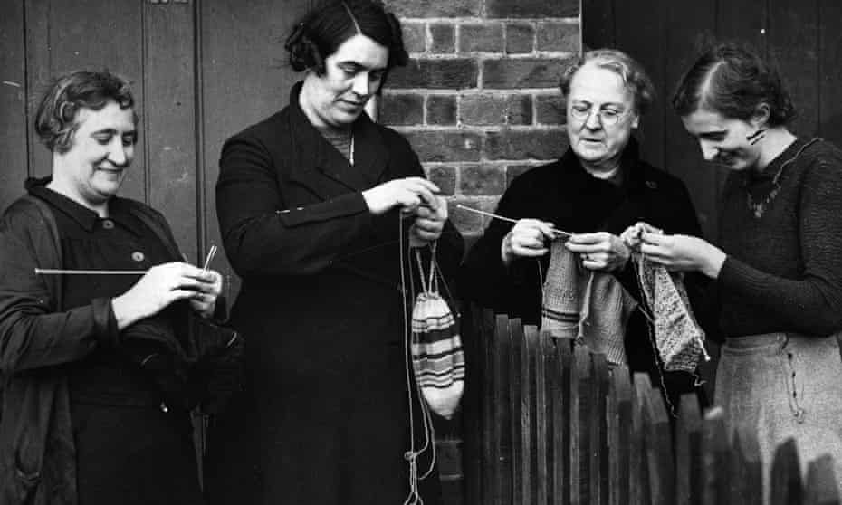 Women knit as they chat over the garden fence in Bayford, Hertfordshire.