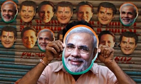 A vendor wears a mask of Modi in Chennai