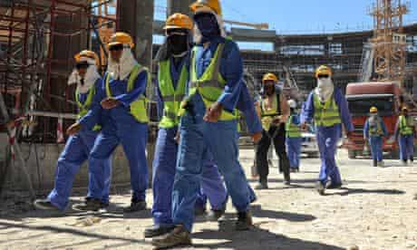 Migrant workers leave a construction site in Doha, Qatar