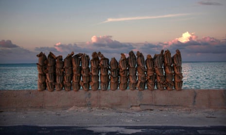 Newly made sandbags sit on a wall on a causeway that connects the town of Bairiki and Betio on South Tarawa in the central Pacific island nation of Kiribati.