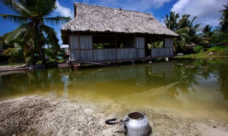 An abandoned house that is affected by seawater during high-tides stands next to a small lagoon near the village of Tangintebu.