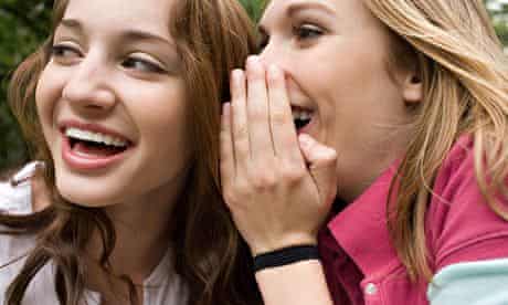 Two teenage girls gossiping