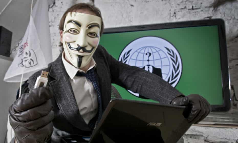 A portrait of an Anonymous activist in his office.