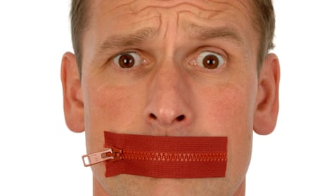 Close-up of man looking quizzical with red zip plastered across his mouth