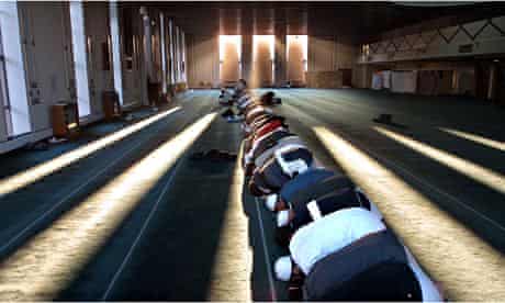 Men pray in Glasgow mosque which was one of two targeted in the city by Britain First