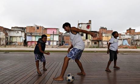 Children play football in the Manguinhos slums in Rio de Janeiro 
