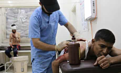 A wounded man is treated at a makeshift