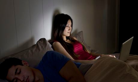 Woman using a computer in bed