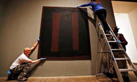 Tate Modern employees rehang Mark Rothko's mural Black on Maroon.