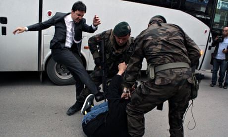 Yusuf Yerkel kicks a protester