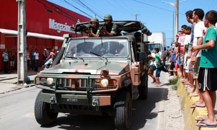 Army soldiers patrol a street during a police strike in Recife