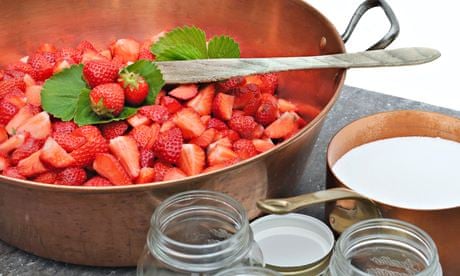 Strawberries in a manufacturer with sugar and jars for making jam