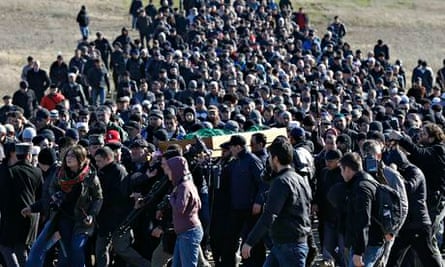 Crimean Tatars gather at a cemetery for the funeral of Reshat Ametov