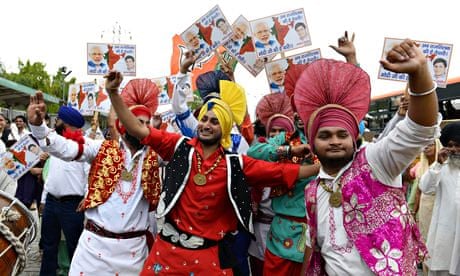 Narendra Modi supporters dance as they wait for the BJP leader to arrive in Delhi