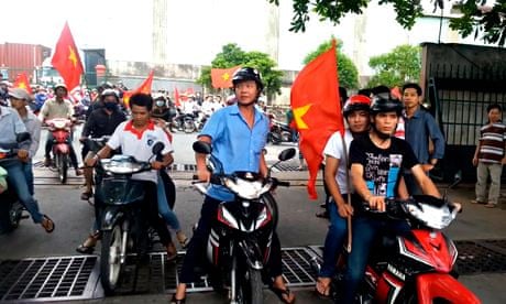 Protesters carry Vietnamese national flags in Binh Duong province