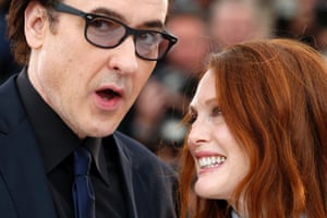 John Cusack and Julianne Moore chat during a photo call for Maps to the Stars.