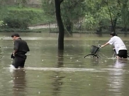North Koreans in a flooded street in Pyongyang in 2007. Severe floods were projected to hamper the country's ability to feed itself for at least a year, according to aid groups.