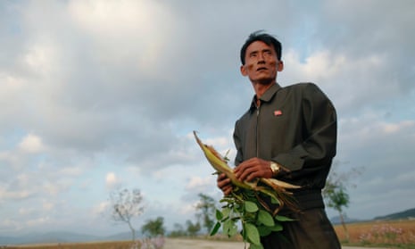 Pak Su-dong, manager of the Soksa-Ri cooperative farm in the area hit by floods and typhoons, shows damage to agricultural products in 2011.